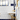 Bathroom with navy tile, white subway walls, and brass faucet fixtures